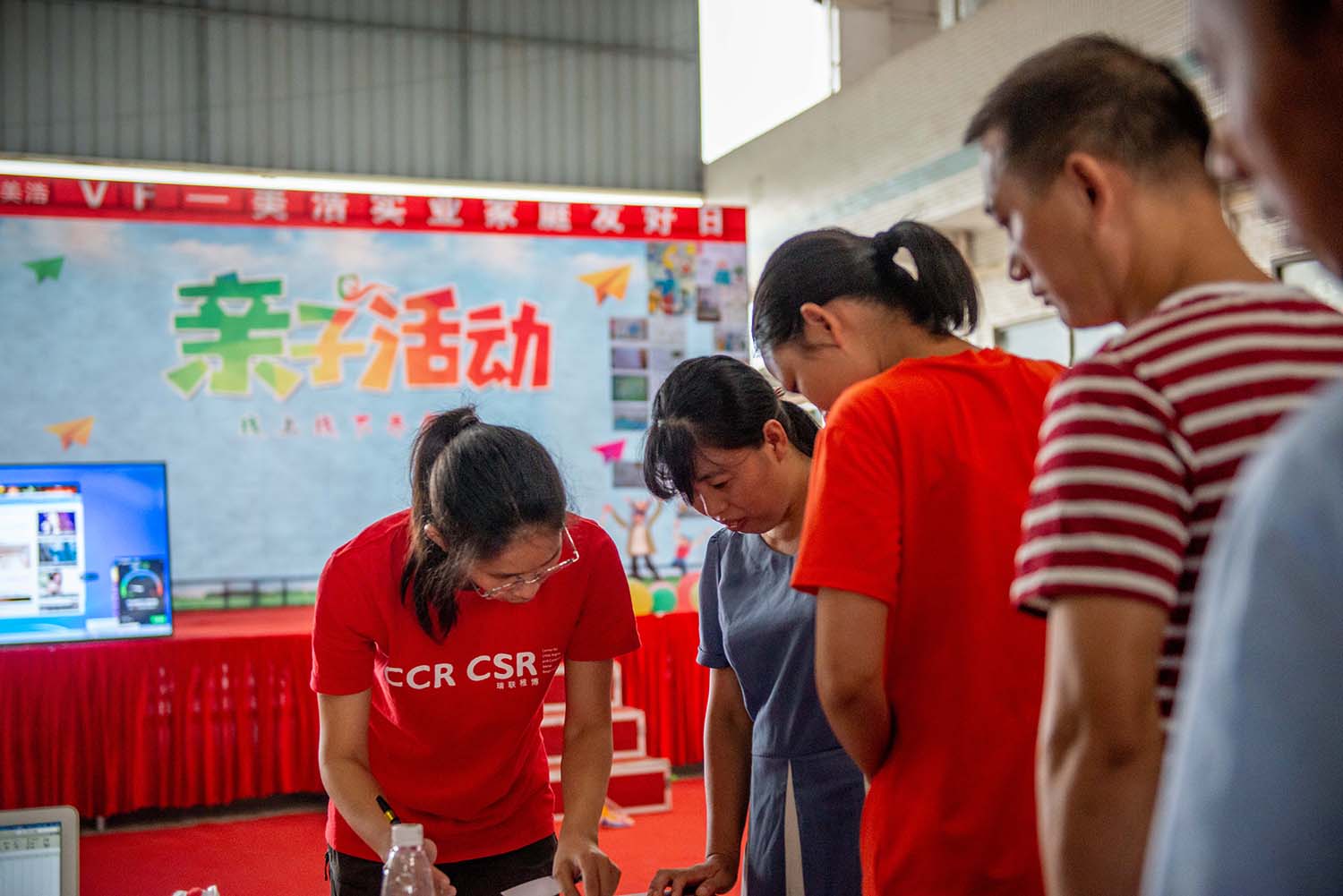 Workers signing up for family-day activities in a factory implementing the "WeCare" programme